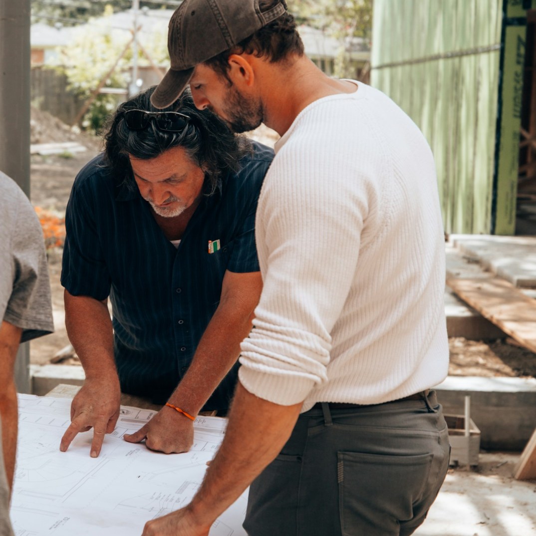Site team reviewing drawings together on site.